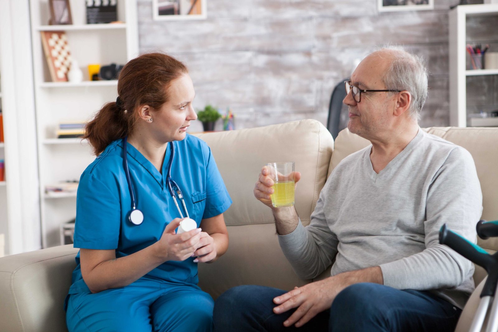 senior-man-lady-nurse-having-conversation-nursing-home-elderly-age-man-taking-his-pills (1)